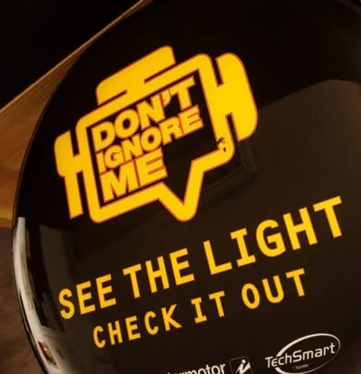 Mechanic inspecting vehicle service items